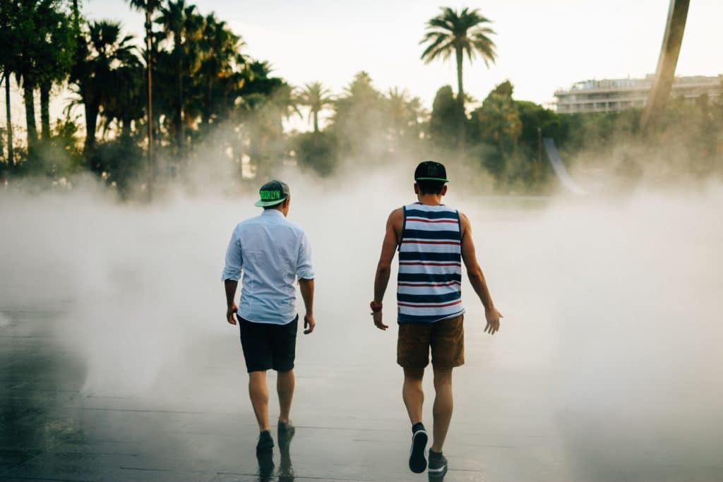 Photo du plateau des brumes de la promenade du Paillon à Nice et de deux hommes marchant de dos vers la brume